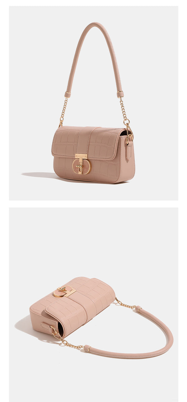 Small structured crocodile-embossed flap shoulder bag with circular gold turn-lock closure and chain-accent strap, detail