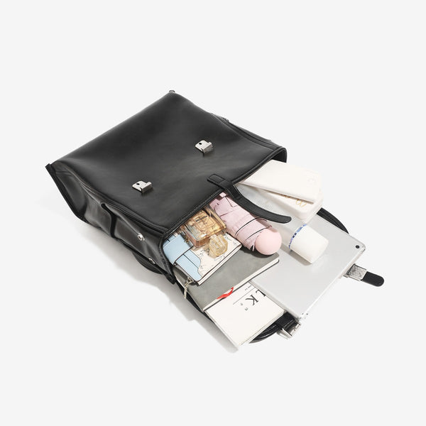 Structured glossy leather-look flap backpack handbag with dual buckle closures, top handle, and silver-tone hardware, detail