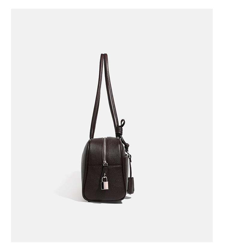 Structured rounded rectangular shoulder bag with pebbled leather-look finish, dual long handles, top zipper, front zip