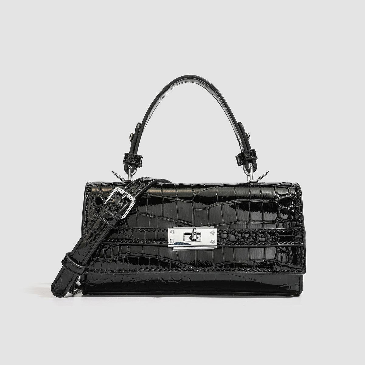 Mini-Handtasche mit strukturierter, rechteckiger Form, glänzender Krokodilprägung in Lederoptik, Drehverschluss in Silberoptik und kurzem