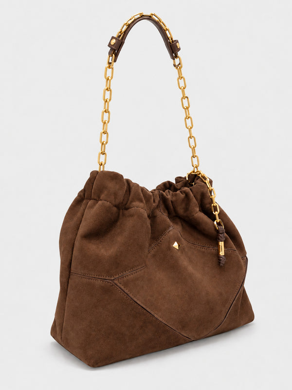 Slouchy suede-look shoulder bag with gathered top, angular stitched paneling, and chunky gold-tone chain strap, detail view