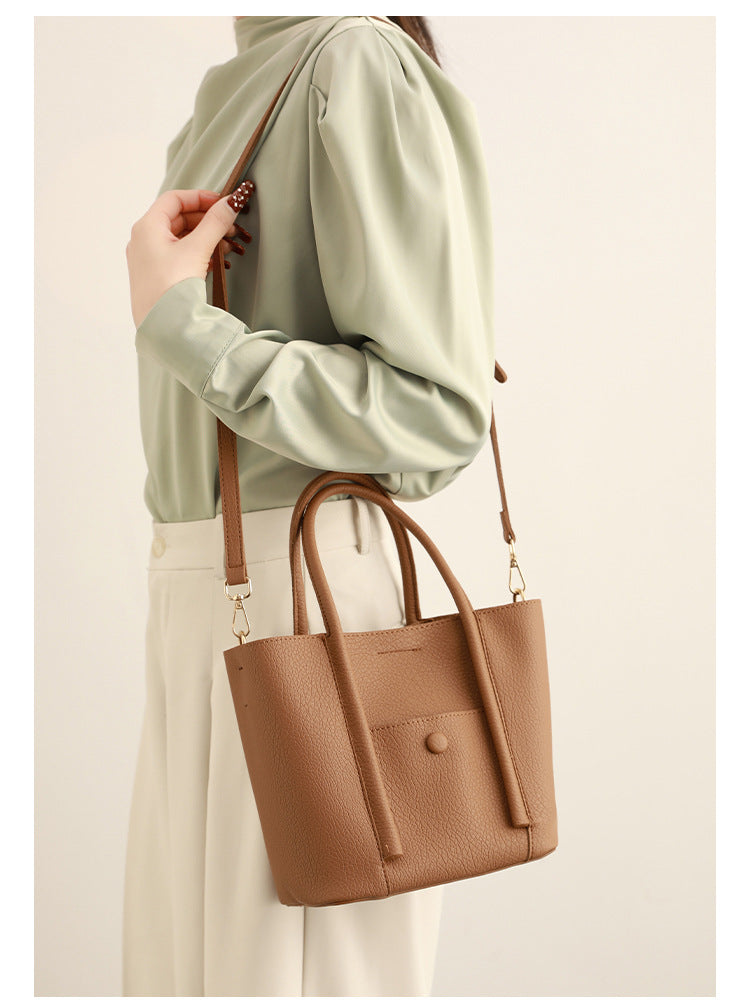 Structured pebbled matte tote bag with front snap pocket, dual top handles, and detachable zip pouch in almond beige, detail