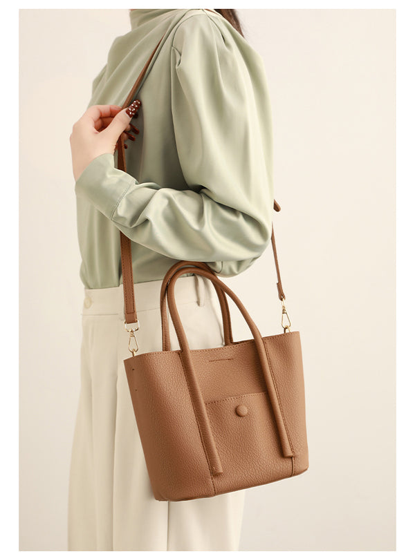 Structured pebbled matte tote bag with front snap pocket, dual top handles, and detachable zip pouch in almond beige, detail