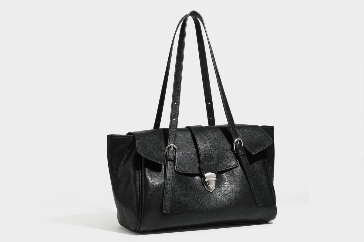 Large structured vintage-style tote bag with flap-front turn-lock closure, twin buckle straps, and double shoulder handles