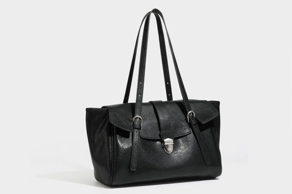 Large structured vintage-style tote bag with flap-front turn-lock closure, twin buckle straps, and double shoulder handles