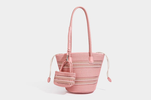 Light blue open-weave woven bucket tote bag with long braided shoulder straps, drawstring side ties, and attached mini pouch