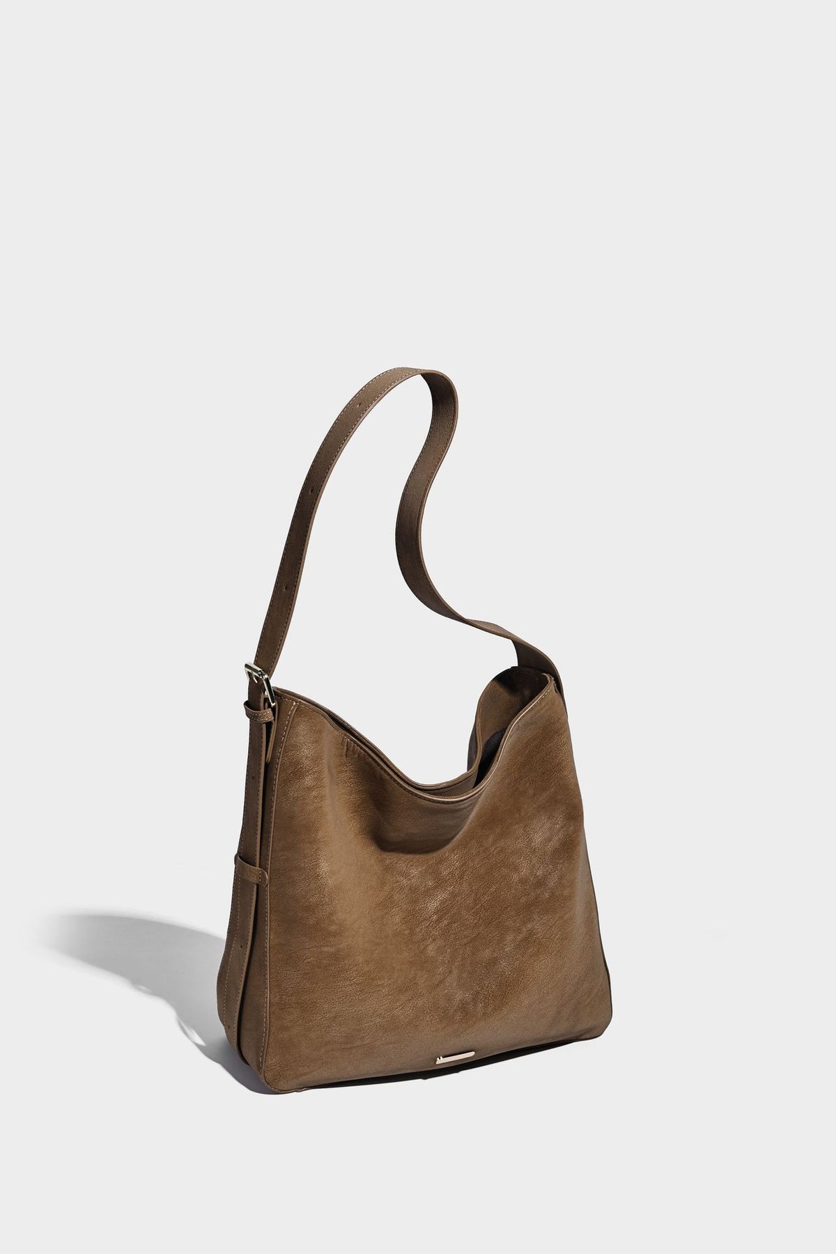 Large slouchy hobo shoulder bag in matte leather-look finish with adjustable strap and gold-tone bar hardware, detail view 12