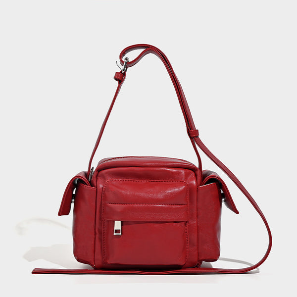 Boxy leather-look crossbody bag with front zip pockets, top zip closure, and long adjustable strap, detail view 9