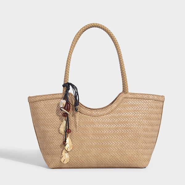 Large open-top woven tote bag with contrasting braided double handles and matching drawstring pouch, detail view 11