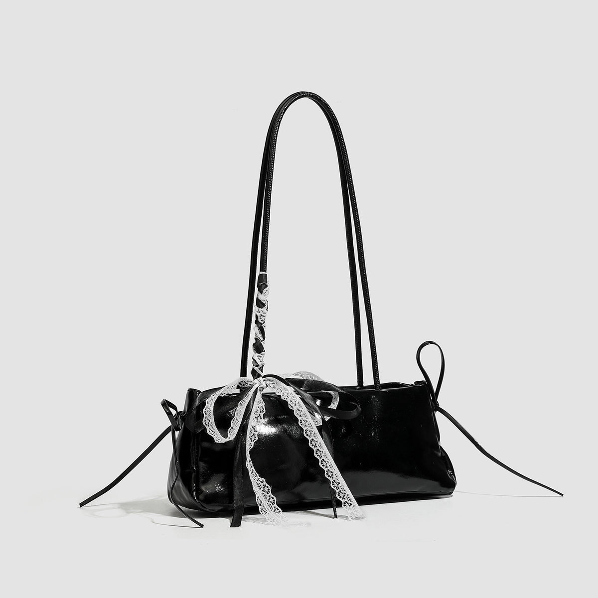 Compact glossy leather-look shoulder bag with lace bow and ribbon trim, detail view 3