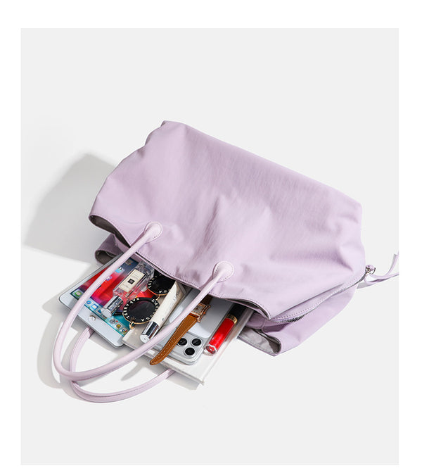 Large soft nylon tote bag with long double handles and zippered top in lavender, detail view 14