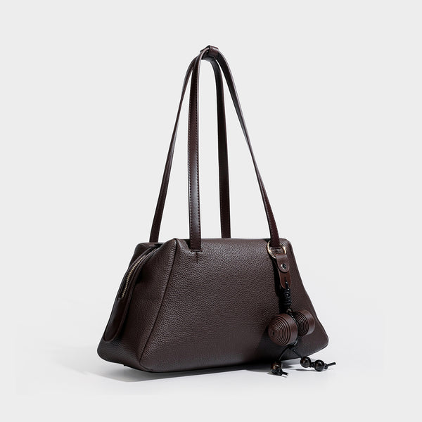 Structured trapezoid shoulder bag in dark brown pebbled leather-look finish with slim double straps, top zip closure, side