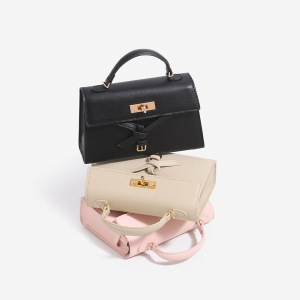 Strukturierte Mini-Henkeltasche mit genarbter matter Oberfläche, Drehverschluss in Goldoptik, schleifenförmigem Riemendetail und kurzem Henkel