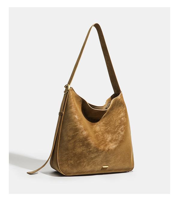 Large slouchy hobo tote bag in distressed dark brown leather-look finish with long shoulder strap, gold-tone ring hardware
