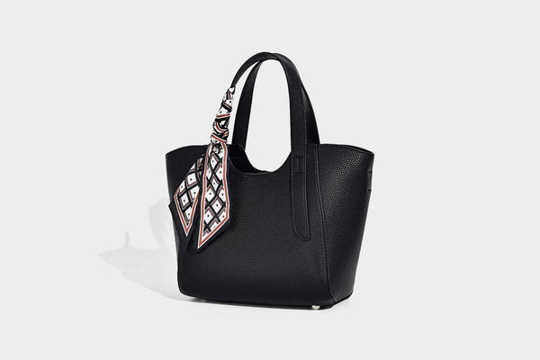 Structured pebbled leather-look tote bag with detachable scarf tie, dual top handles, and adjustable crossbody strap, detail