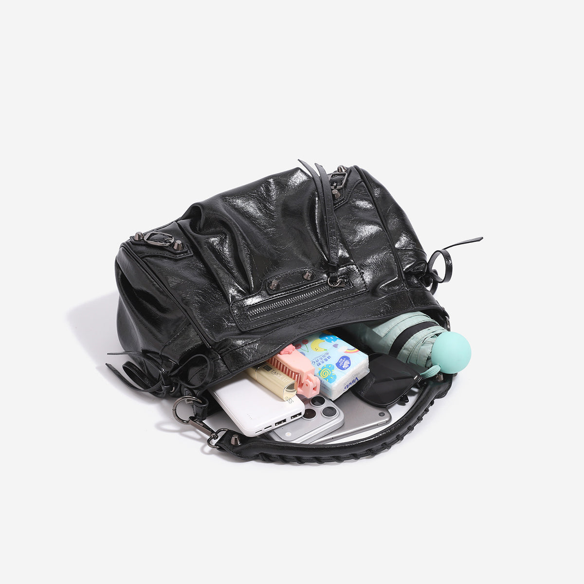 Slouchy glossy crinkle leather-look shoulder bag with silver stud accents, tassel ties, front zip pocket, and top handle