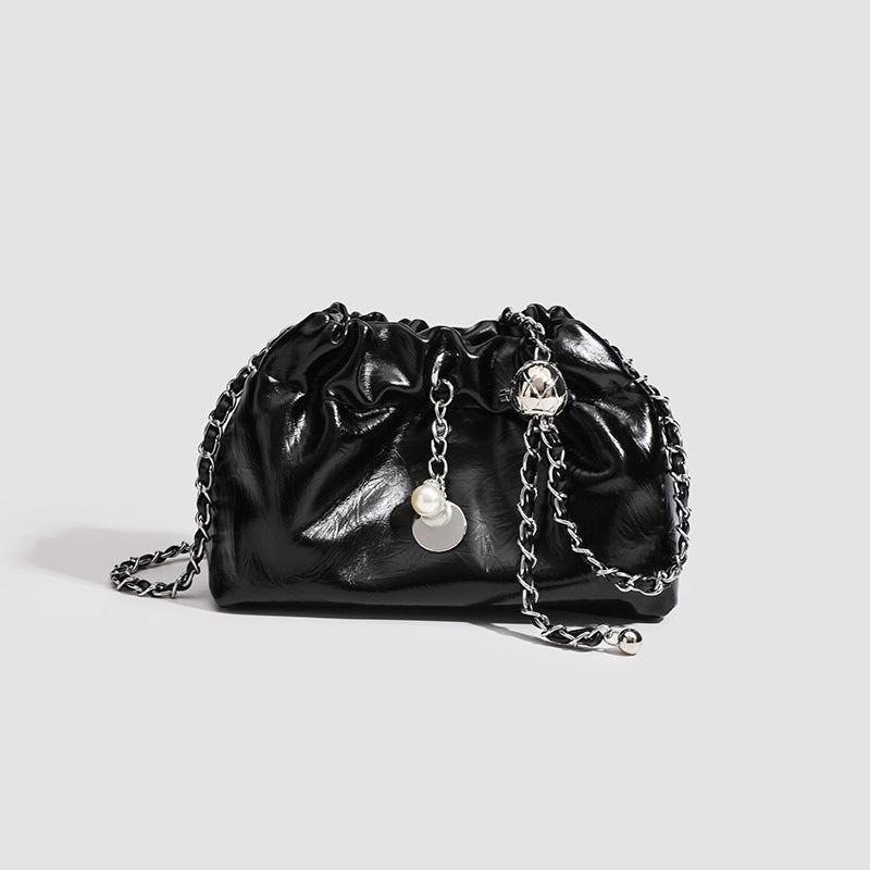 Small ruched drawstring bucket bag with twisted-link chain strap and pearl charm pull, detail view 7
