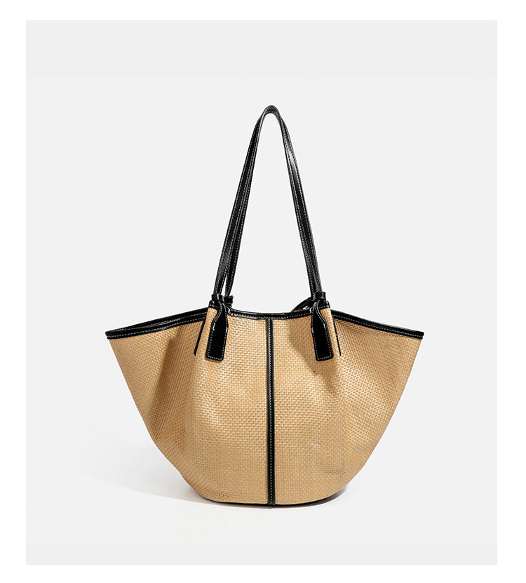 Tan woven tote bag with contrasting leather-look trim, long shoulder straps, and detachable rectangular zip pouch, detail