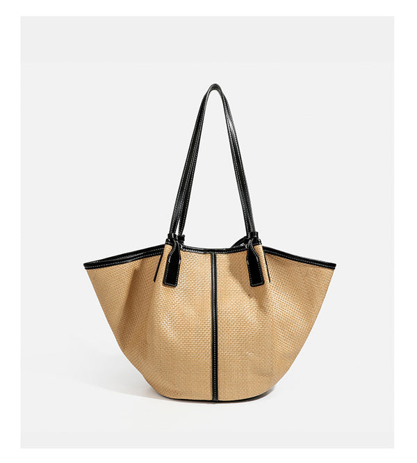 Tan woven tote bag with contrasting leather-look trim, long shoulder straps, and detachable rectangular zip pouch, detail