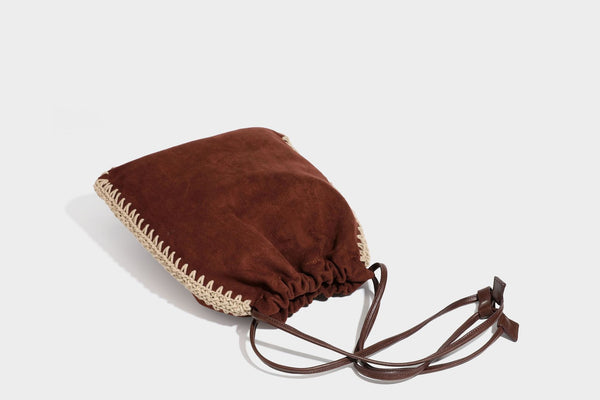 Matte suede-look drawstring bucket bag with cream braided woven edge trim and slim adjustable leather-look shoulder strap