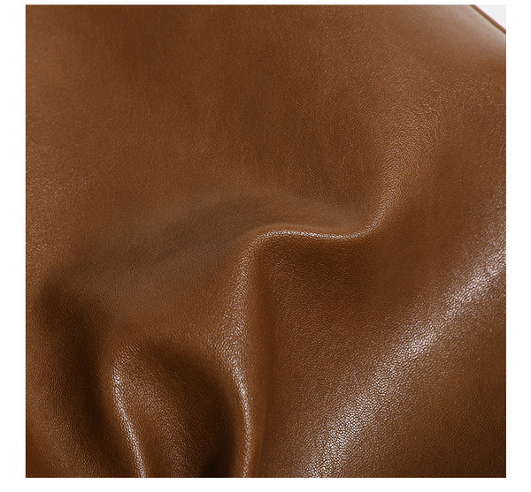 Smooth leather-look hobo bag with gold-tone ring hardware, contrast stitching, top handle and adjustable crossbody strap