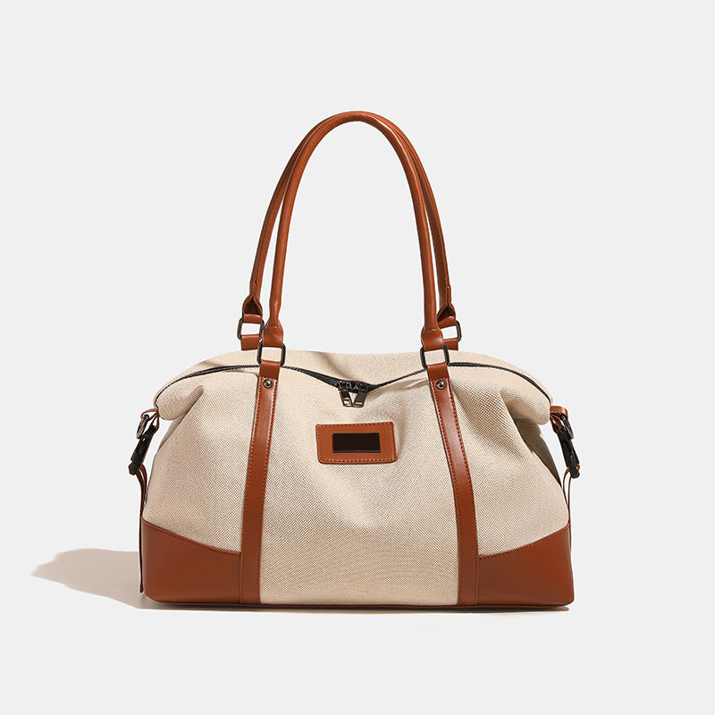 Large cream canvas tote bag with dark leather-look trim, dual top handles, and detachable shoulder strap, detail view 7
