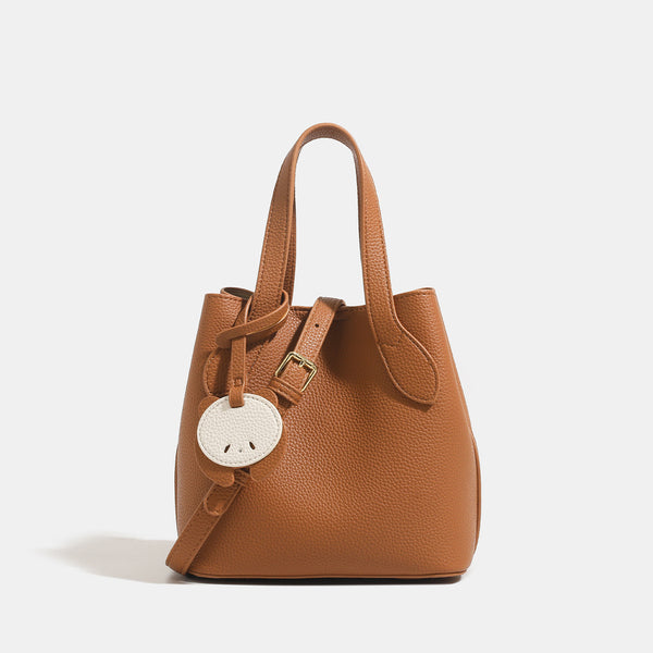 Pebbled leather-look bucket tote with elephant charm pendant, dual top handles, and detachable shoulder strap, detail view 8