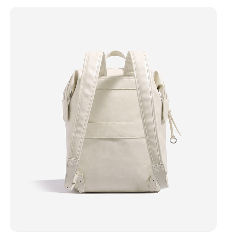 Large smooth leather-look backpack with multi-pocket front panel, dual zip closure, and silver-tone hardware, detail view 11