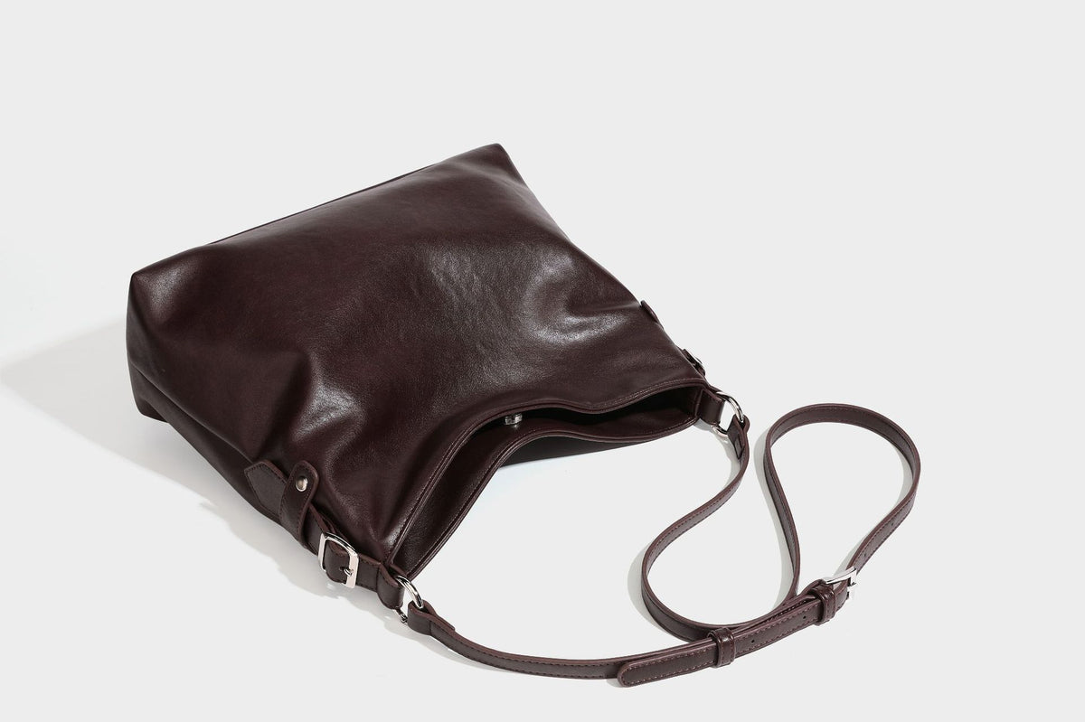 Large slouchy hobo shoulder bag in dark brown with smooth leather-look finish, adjustable strap, and silver-tone hardware