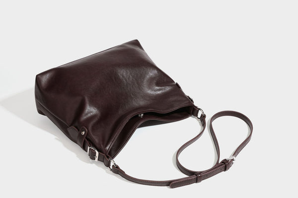 Large slouchy hobo shoulder bag in dark brown with smooth leather-look finish, adjustable strap, and silver-tone hardware