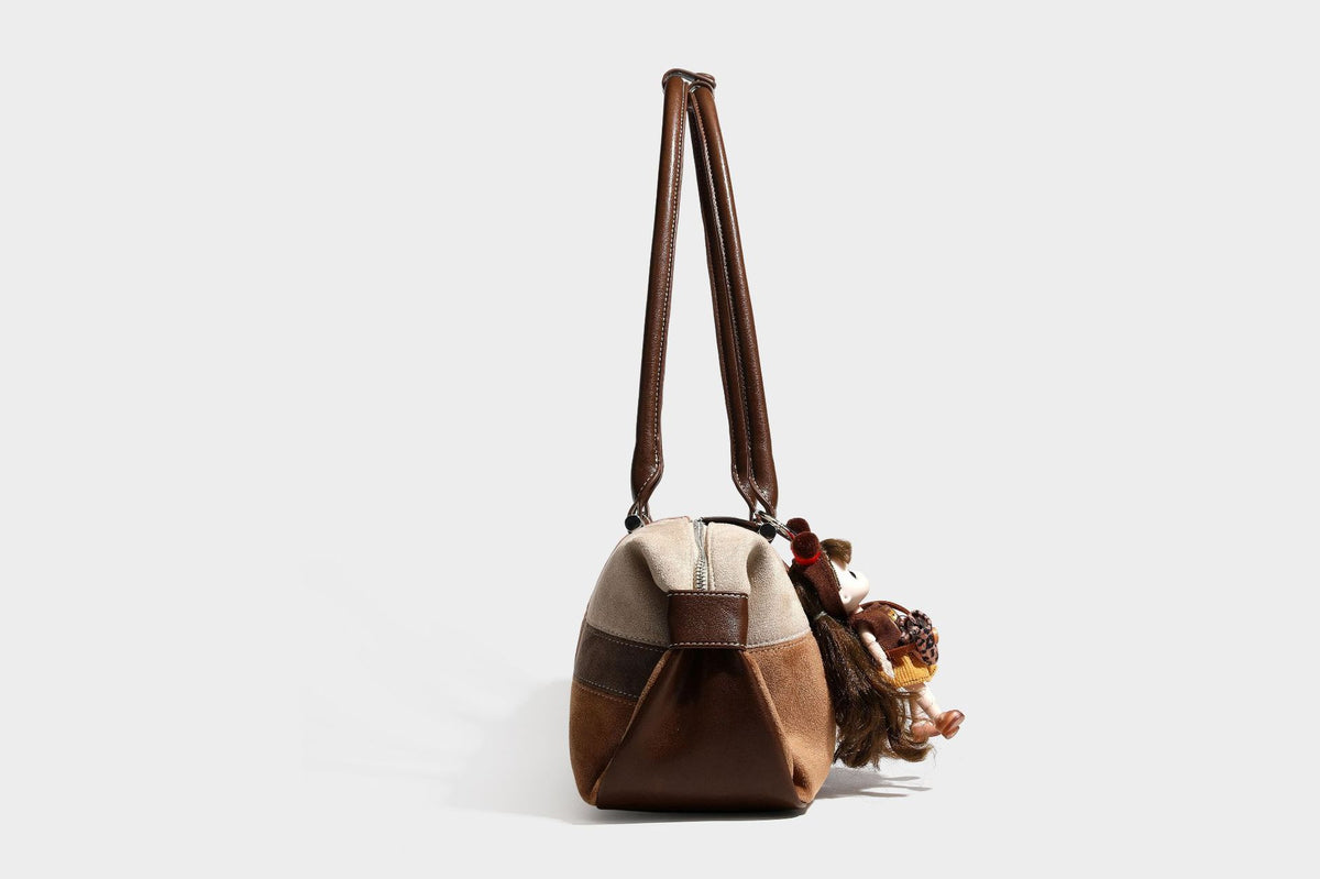 Patchwork suede-look barrel shoulder bag in brown, rust, tan, beige, and gray panels with double leather-look straps and