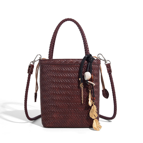 Small structured woven-texture tote bag with braided top handles and drawstring inner pouch, detail view 5