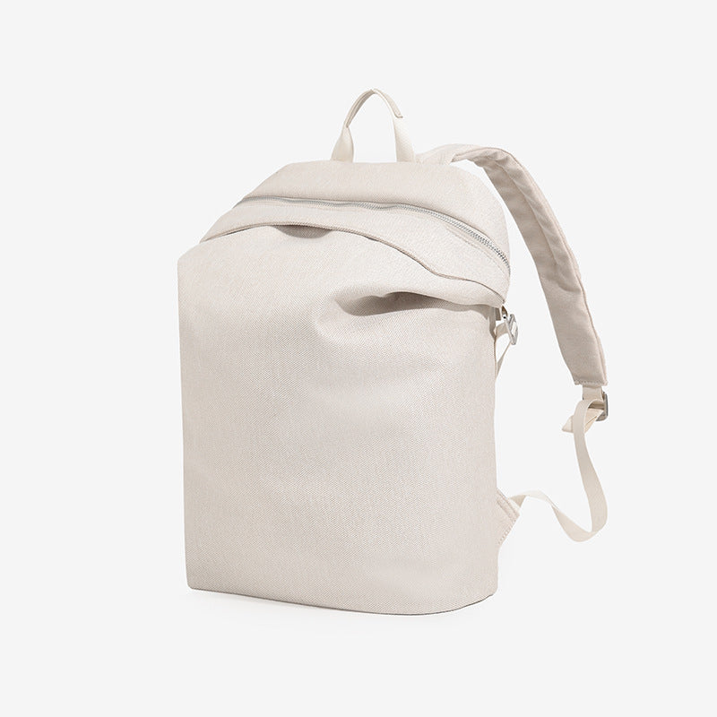 Structured matte nylon backpack with top zip closure, front zip pocket, top carry handle, and adjustable shoulder straps