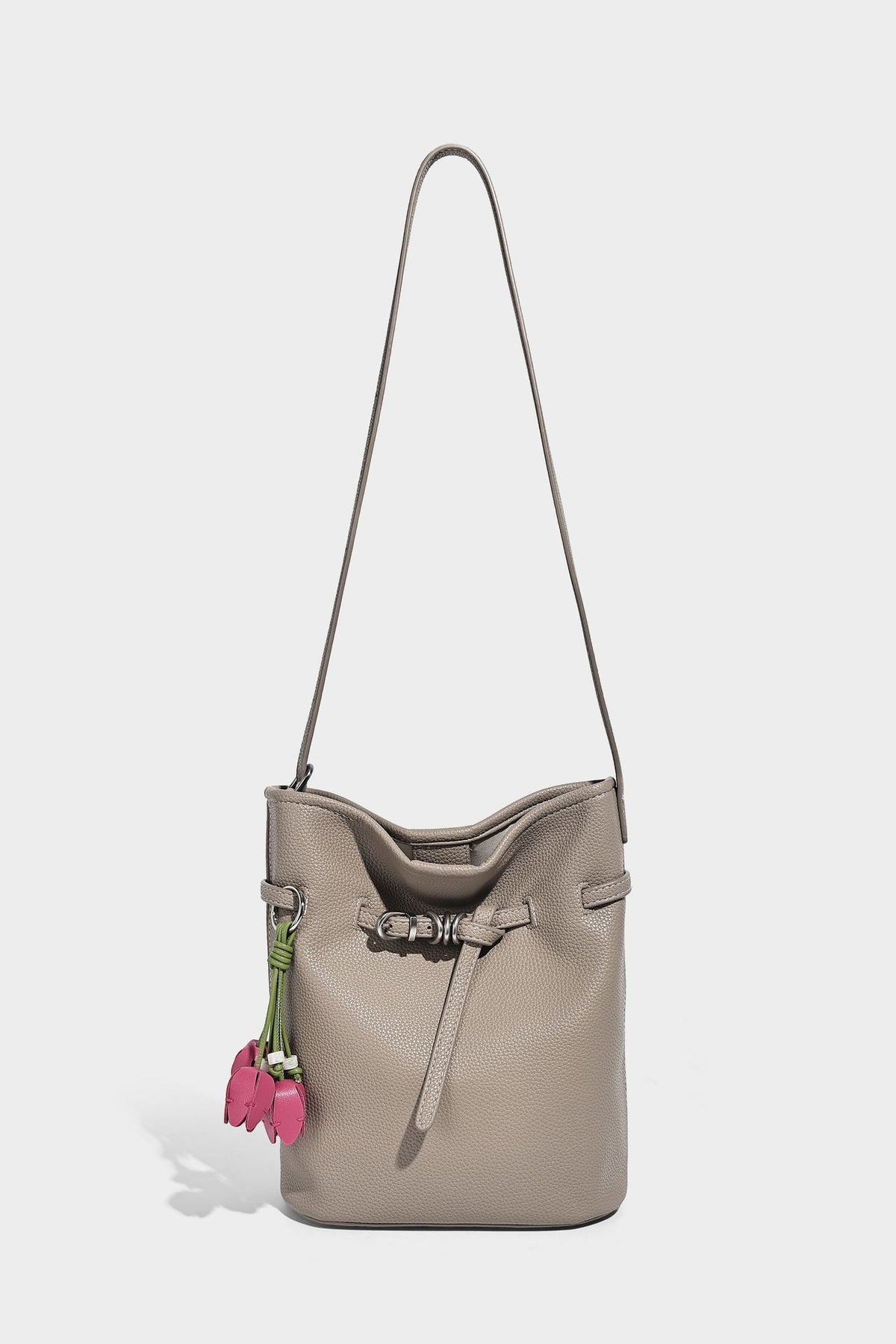 Small pebbled leather-look bucket bag with front drawstring toggle hardware and long adjustable shoulder strap, detail view