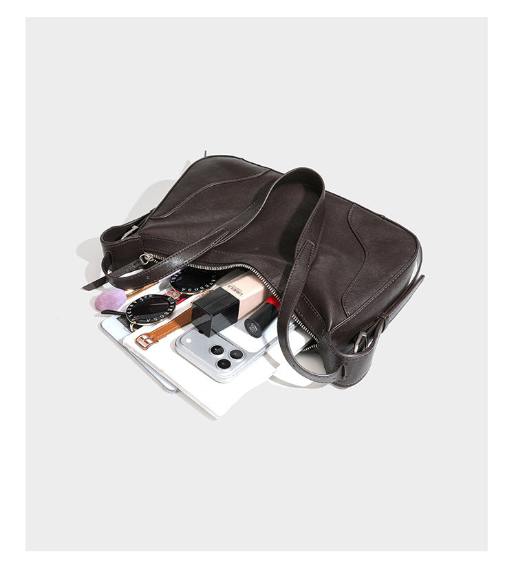 Dark brown curved zip-top hobo shoulder bag with slim adjustable strap and silver-tone hardware, detail view 16
