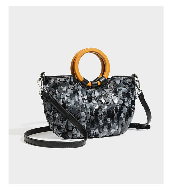 Small sequin half-moon handbag with circular wood-look ring handles and detachable leather-look shoulder strap, detail view