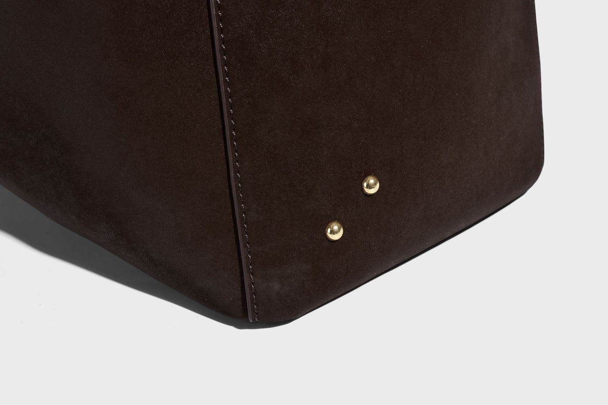 Oversized trapezoid tote bag with matte leather-look finish, gold-tone rivets, and long shoulder strap, detail view 20