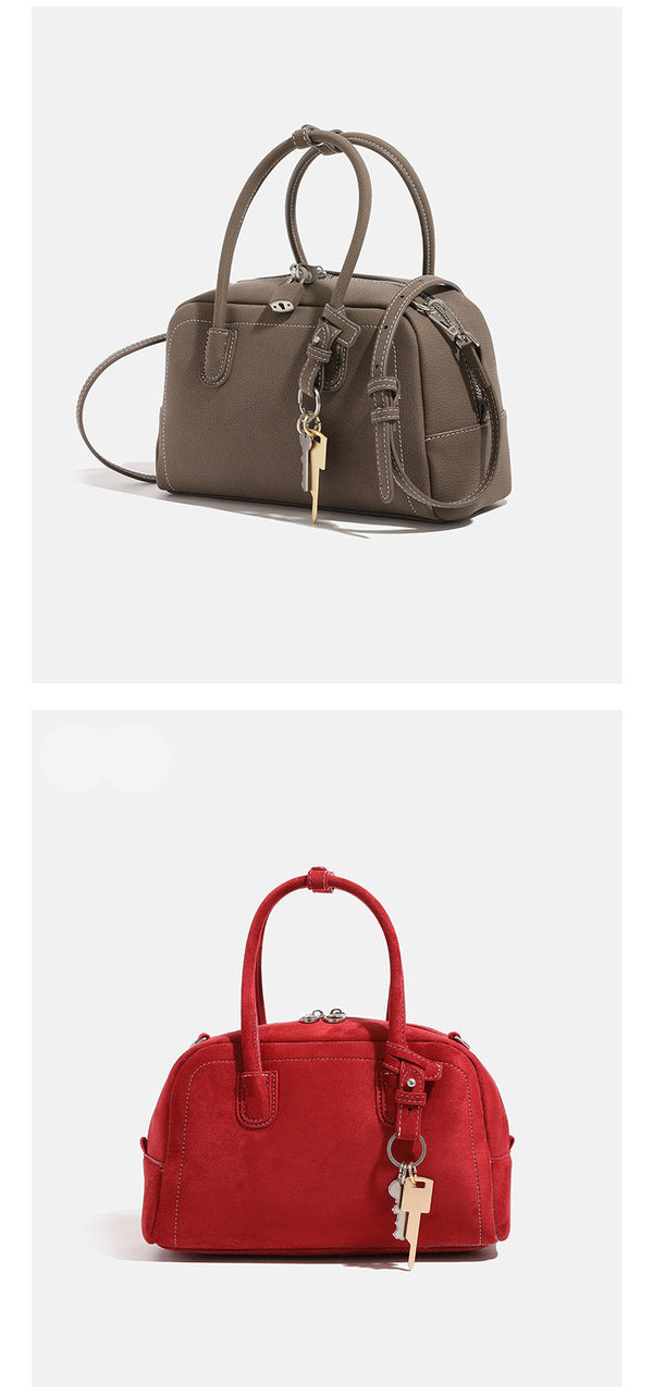 Compact retro Boston satchel bag with matte suede-look finish, twin rounded top handles, double zip closure with silver-tone