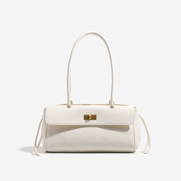 Structured black baguette bag with diamond-quilted front panel, gold-tone turn-lock flap closure, and dual looped top