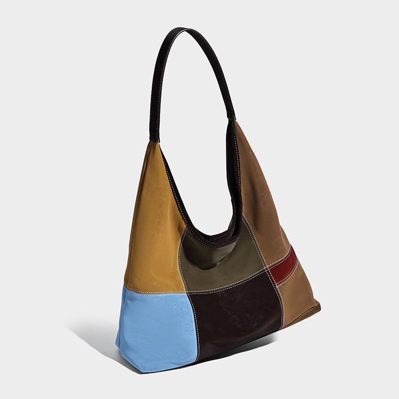 Multicolor patchwork hobo shoulder bag with brown tan olive mustard red and blue suede-look panels, contrast white stitching