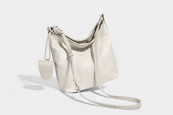 Diamond-quilted leather-look bucket shoulder bag with knotted strap accent and attached mini pouch, detail view 29
