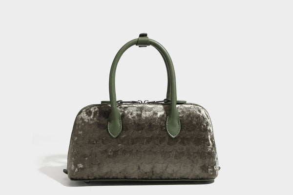 Small structured satchel bag in dark brown velvet-like textured finish with leather-look trim, silver-tone turn-lock bar