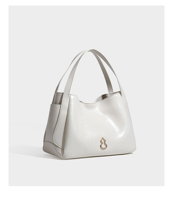 Black glossy crinkled leather-look convertible shoulder tote bag with gold gourd-shaped emblem hardware and detachable