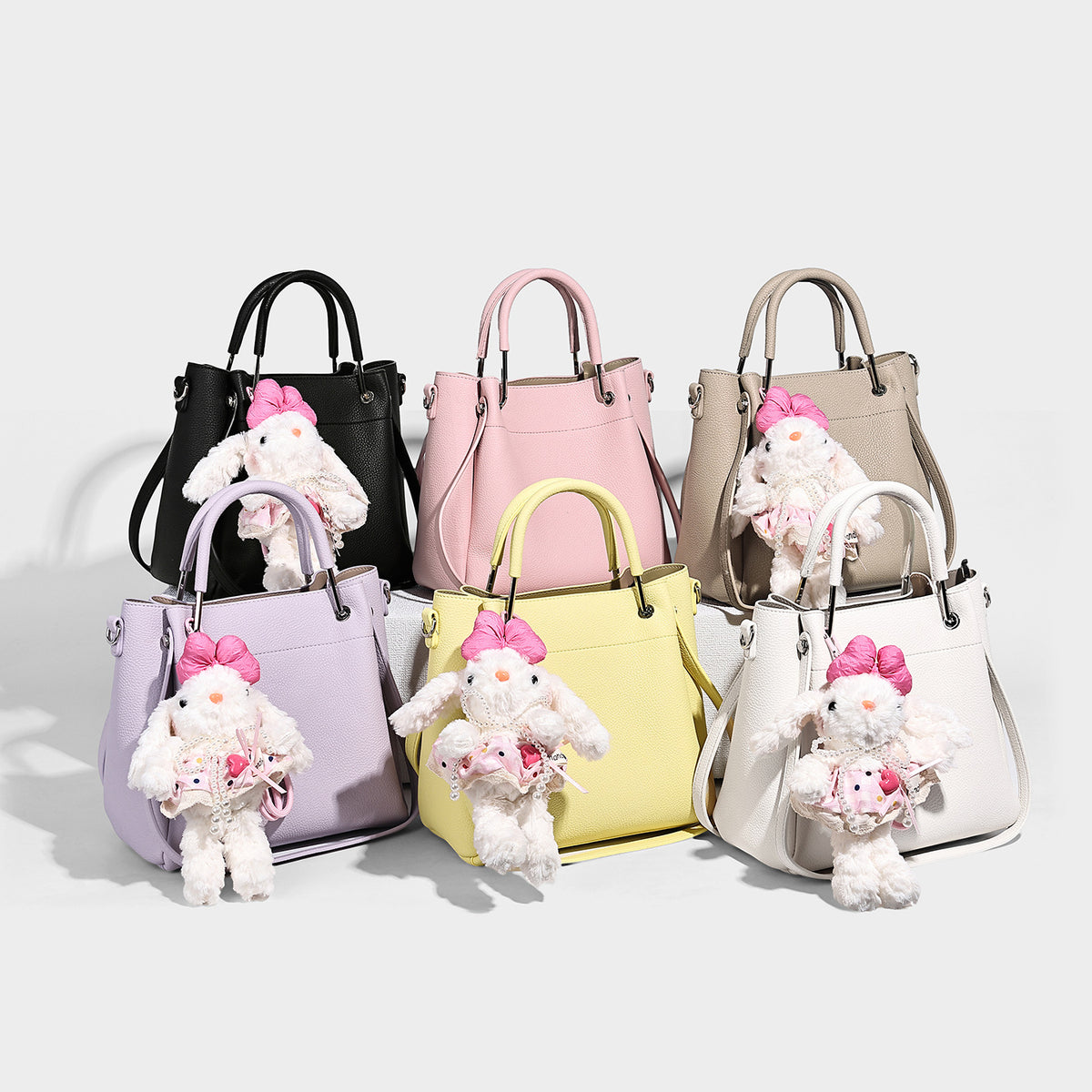Structured pebbled leather-look bucket tote bag with rounded top handles, detachable shoulder strap, silver-tone hardware