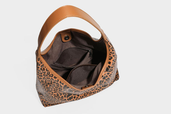 Glossy leopard-print slouchy shoulder bag with long strap and detachable tan zip pouch, detail view 33