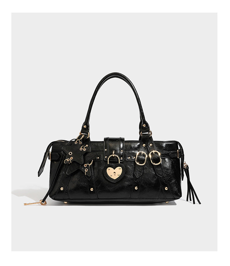 Dark brown glossy crinkled leather-look barrel bag with gold heart lock, dome studs, star charm, dual top handles and, detail