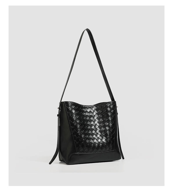 Large black bucket shoulder bag with diamond woven leather-look front panel, smooth side panels, magnetic snap closure, and