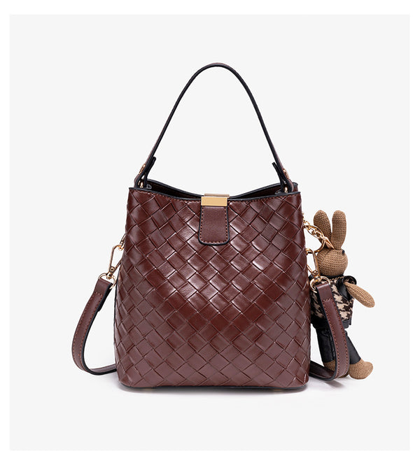 Brown woven-emboss leather-look bucket bag with short top handle, detachable crossbody strap, gold-tone hardware, and rabbit