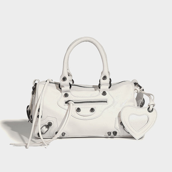 Glossy studded mini satchel bag with braided top handles, front zip pocket, heart charm, and detachable crossbody strap