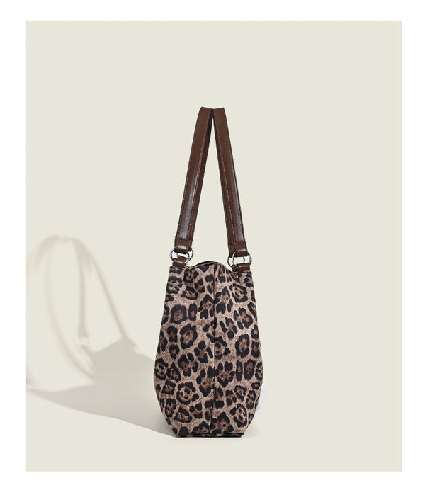 Leopard-print fabric tote bag with white plush teddy bear appliqué and brown leather-look shoulder straps, detail view 11